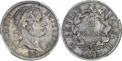 a close up of a coin on a white surface