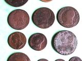 several different coins are arranged in a row on a table