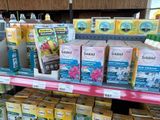many boxes of tea on the shelf in the store
