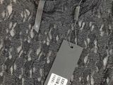 the label on a sweater is attached to a hanger on a hanger