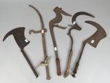 four old tools that are sitting on a white surface