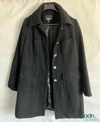 a black jacket hanging on a hanger on a white background