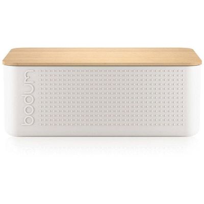 a white box with a wooden lid sitting on top of a white surface