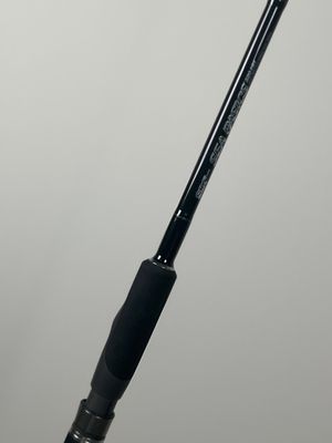 a close up of a fishing rod on a white surface