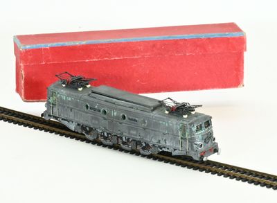 a toy train that is on the tracks next to a red box