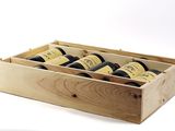 bottles of wine are in a wooden box on a white surface