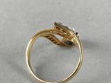a close up of a gold ring with a diamond on it