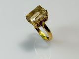 a close up of a ring with a green stone on it