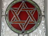 a stained glass window with a star of david on it