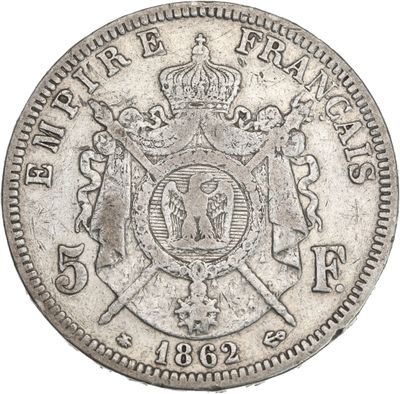 a close up of a silver coin with a crown on it