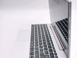 a laptop computer sitting on top of a white table