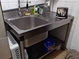 a kitchen with a sink and a refrigerator in it