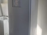 a white refrigerator sitting in a kitchen next to a washing machine