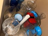 a box full of empty plastic cups and a toothbrush