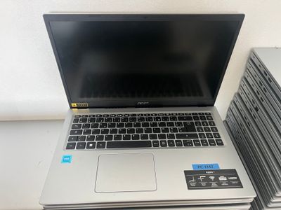 an open laptop computer sitting on top of a stack of books
