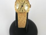 an image of a close up of a watch on a stand
