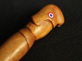 a wooden stick with a red eye on top of it