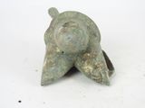 a small statue of a snail on a white surface