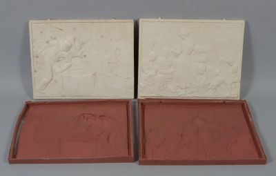 pair of red and white boxes with carvings on them on a gray surface