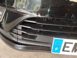 a close up of a black car with a license plate on it