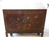 a brown cabinet with birds and flowers on it