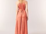 the back of a woman in an orange dress is facing away