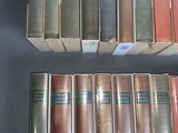 several books are stacked on top of each other on a table