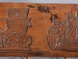 an image of a wooden plaque with a ship and people on it
