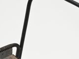 a black chair with a metal frame and a black seat