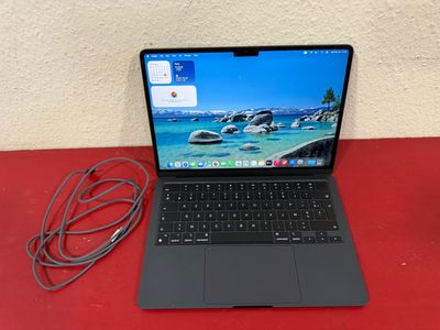 a laptop that is sitting on a red table