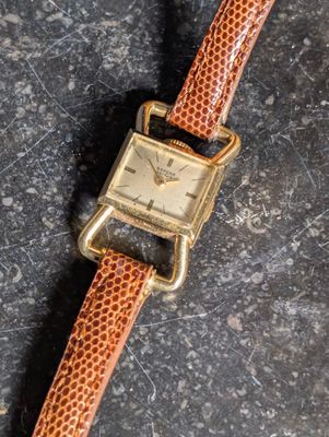 an image of a wrist watch on a stone surface