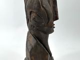 an image of a sculpture of a woman ' s head on a stone base