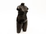 a statue of a woman that is standing on a white surface