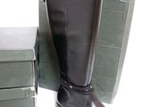 a pair of black boots that are next to a box