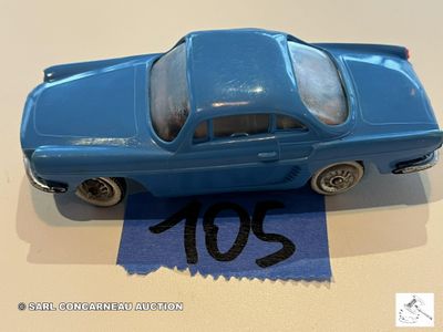 une petite voiture bleue posée sur une feuille de papier