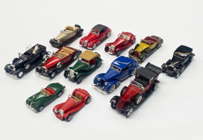 several toy cars are lined up in a row on a white surface