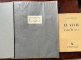 two books are sitting on a table next to a pair of scissors