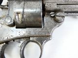 a gun that is sitting on a white surface