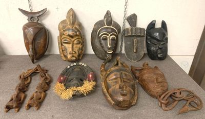 many different types of african masks displayed on a table