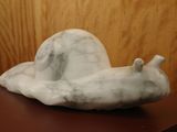 a sculpture of a snail sitting on a table