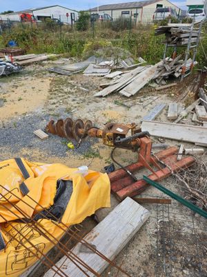 un tas de matériaux de construction posé à même le sol, à côté d'un bâtiment