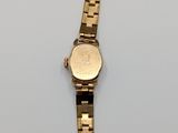 an image of a gold watch on a white surface