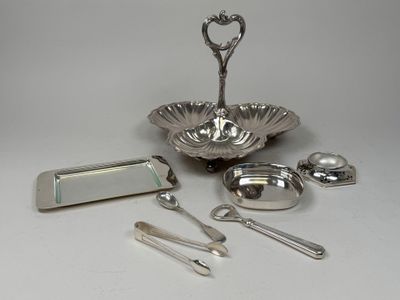a silver plate with spoons, spoons, and other items on it