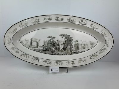 an oval platter with a scene of a farm scene on it
