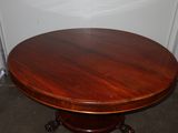 a round table with a wooden top in a room