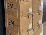 boxes stacked on a pallet in front of a black wall