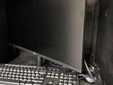 a keyboard and a monitor on a desk in a room