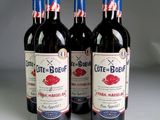 three bottles of red wine sitting on top of a white table