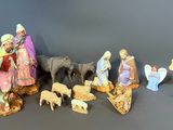 many figurines of people and animals on a table