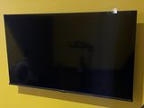a flat screen tv mounted on the wall in the living room